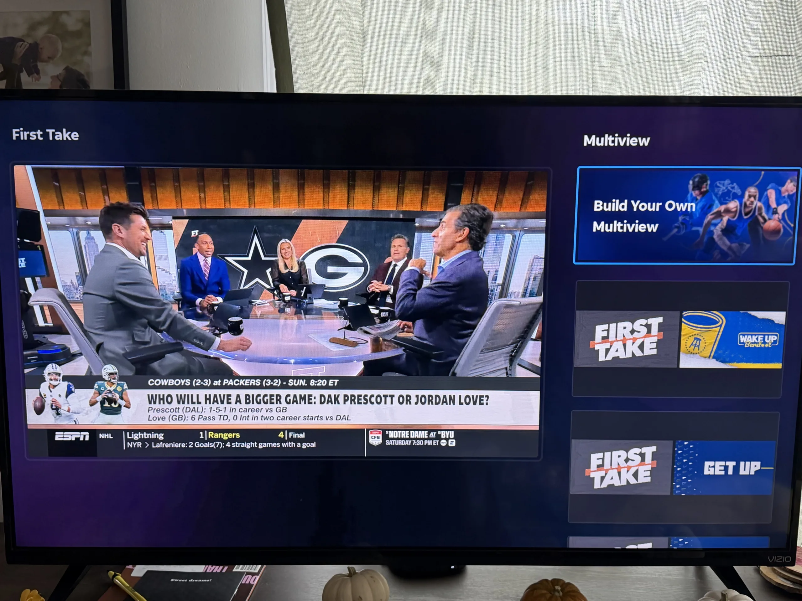 DIRECTV Build Multiview A television displaying a studio show on ESPN next to Build Your Own Multiview menu options.
