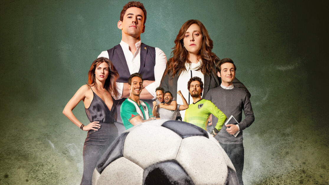 The cast of Club de Cuervos stands behind a soccer ball.