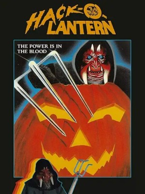A hooded figure wearing a demonic mask stabs at a jack-o-lantern with a pitchfork.