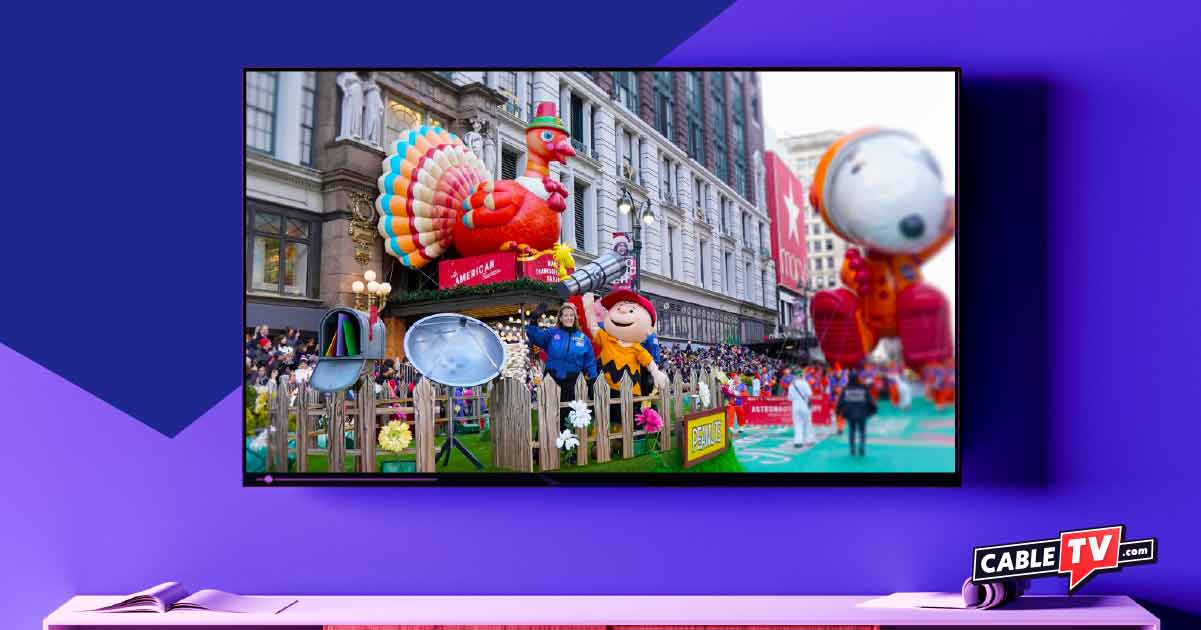 Macy's Thanksgiving Day Parade floats appear on a flat-screen TV.