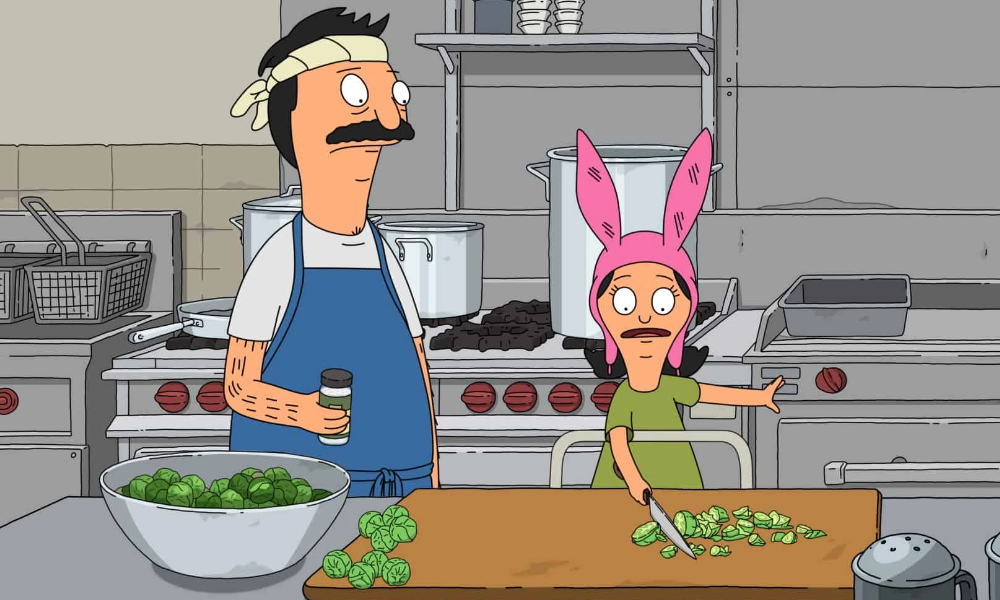 Bob, a cartoon man with a mustache and a bandana around his head, is teaching his daughter Louise (a cartoon girl with a pink bunny hat) how to chop vegetables.