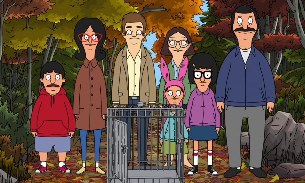 The Belchers stare blankly at an empty turkey cage. Behind them, the trees are turning fall colors.