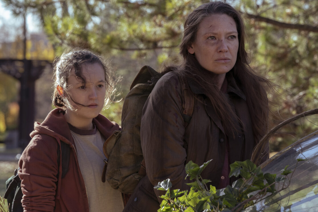 Bella Ramsey and Anna Torv walking outdoors from HBO's The Last of Us.