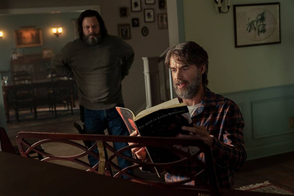 Nick Offerman and Murray Bartlett standing around a piano from episode 3 of The Last of Us.