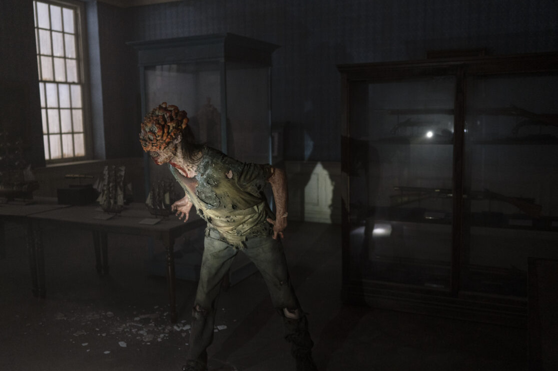 A clicker monster in a darkened museum from the HBO show The Last of Us.