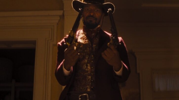 Django Freeman (Jamie Foxx) wields two pistols in a shootout in a scene from Django Unchained.