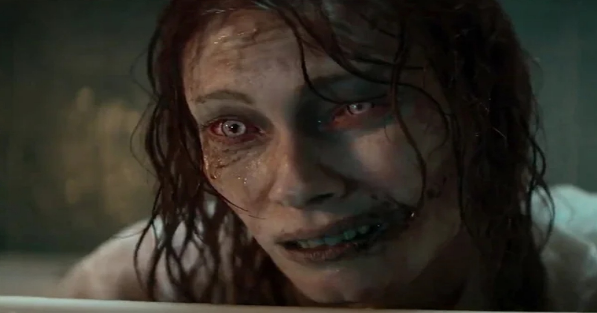 A possessed woman leans over the edge of a bathtub in Evil Dead Rise.