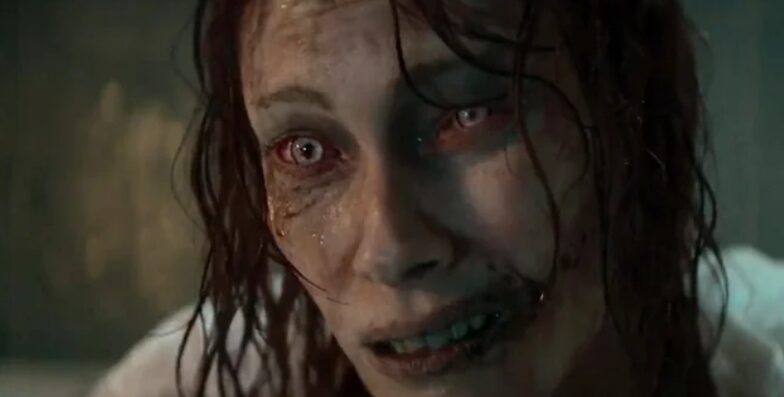 A possessed woman leans over the edge of a bathtub in Evil Dead Rise.