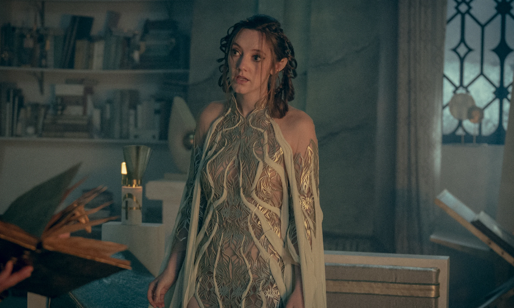 Merwyn, an elf woman with braided hair wearing a silver gown.