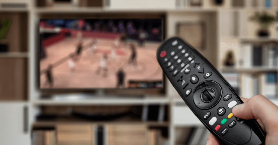 TV remote in front of television showing basketball game