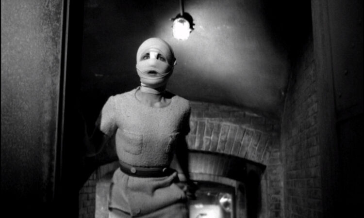 A woman, head wrapped in bandages, cautiously climbs a staircase in Eyes Without a Face.