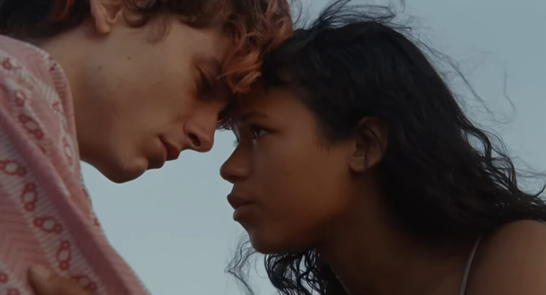 Lee (Timothée Chalamet) and (Maren) Taylor Russell, foreheads touching, gaze into each other's eyes.