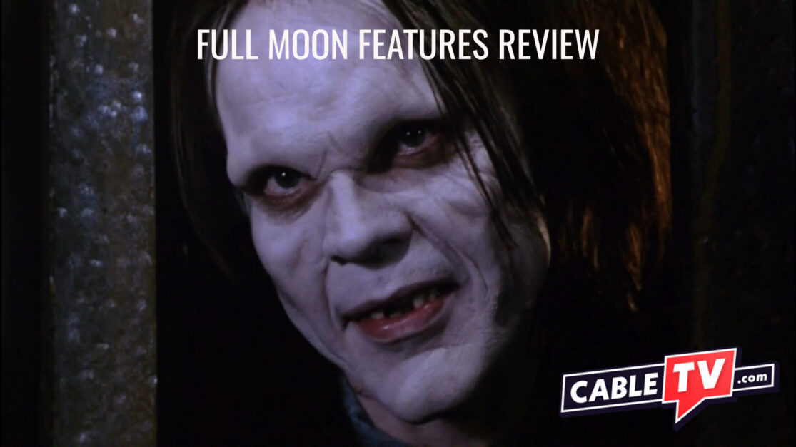 A vampire peers out from a cage. Text on the image says "Full Moon Features Review."