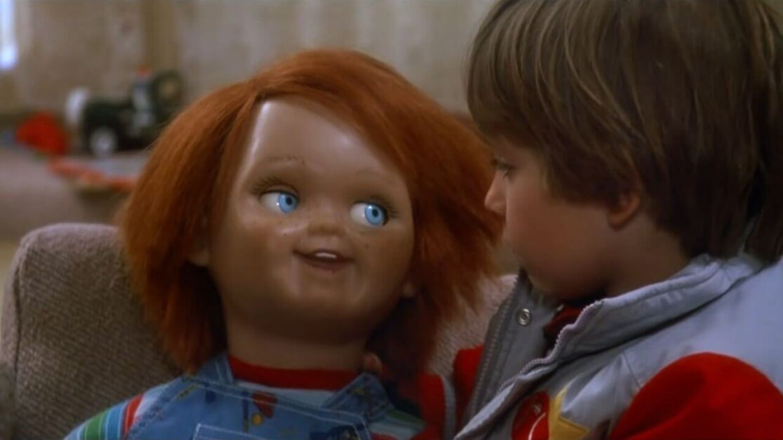 A red-headed doll chats with a little boy