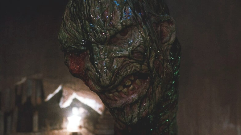 A huge, looming burn-scarred head of Freddy Krueger leers into the camera lens.