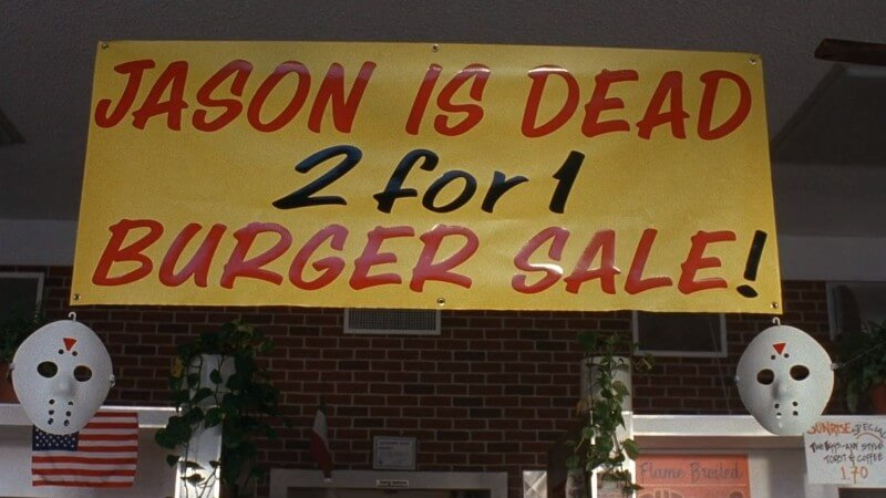 A banner, flanked by hockey masks, reads, JASON IS DEAD—2 FOR 1 BURGER SALE