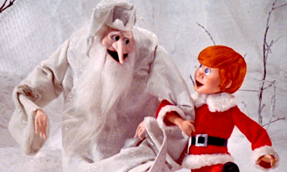 A young Kris Kringle dancing with an old wintery wizard.