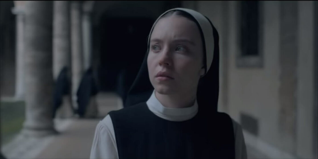 A fresh-faced nun looks cautiously at something off-screen