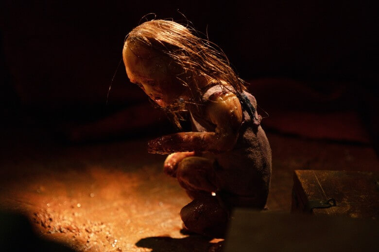 A stopmotion puppet hunched over
