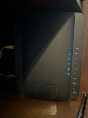 IMG_7593 An Optimum router, a black rectangular device with blue lights.