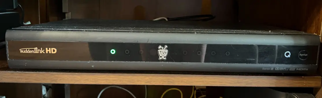 A Suddenlink cable box: a horizontal rectangular device with the Suddenlink logo.