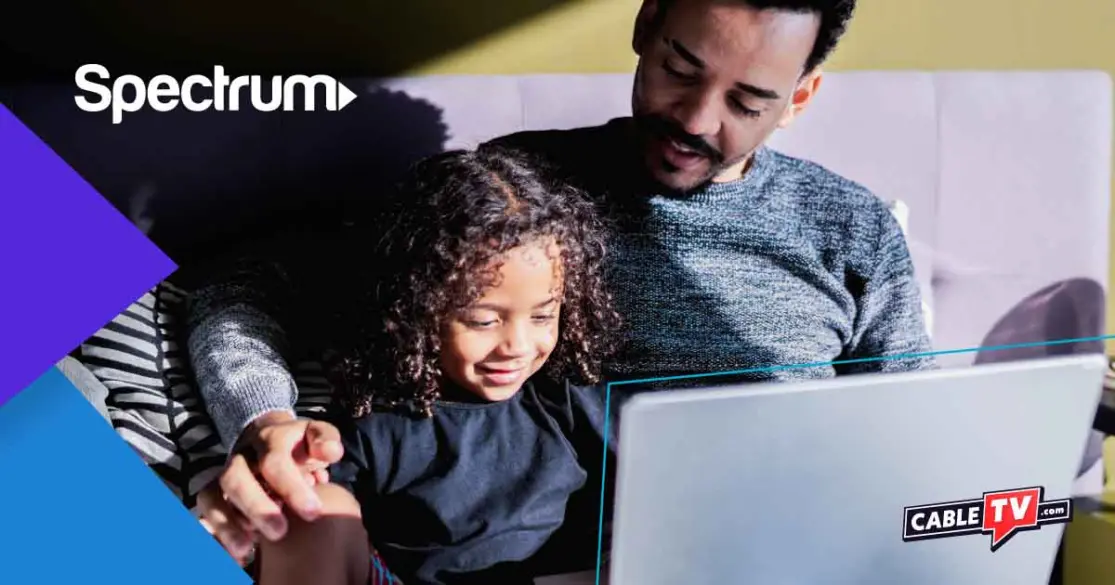 CTV_Spectrum-internet A man and child sit on a couch, exploring Spectrum internet plans together on a laptop. The Spectrum and CableTV logos are clearly visible.