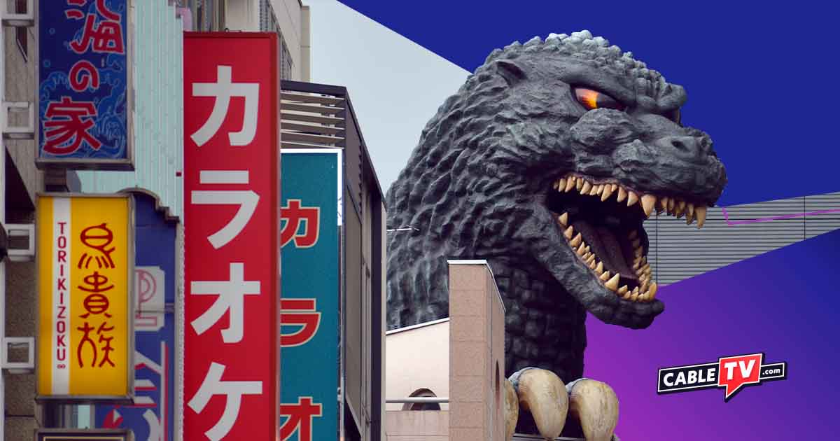 Godzilla walking between buildings.
