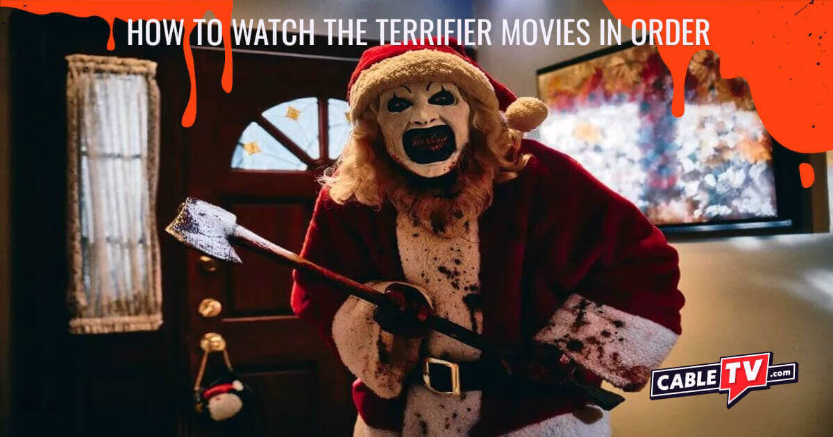 Image of an evil clown dressed as Santa Claus brandishing an axe in a scene from Terrifier 3. The CableTV.com logo is at the bottom right. Across the top, it reads, "How to Watch the Terrifier Movies in Order"