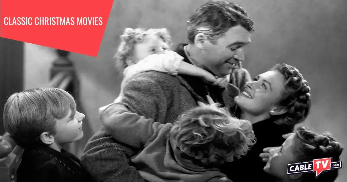 In a scene from It's a Wonderful Life, a man is mobbed by his adoring family. It's a Wonderful Life is one of the 14 classic Christmas movies covered in this guide.