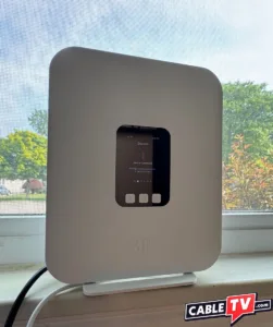 TMobile 5G Window A T-Mobile 5G gateway placed on a sill in front of a large window.