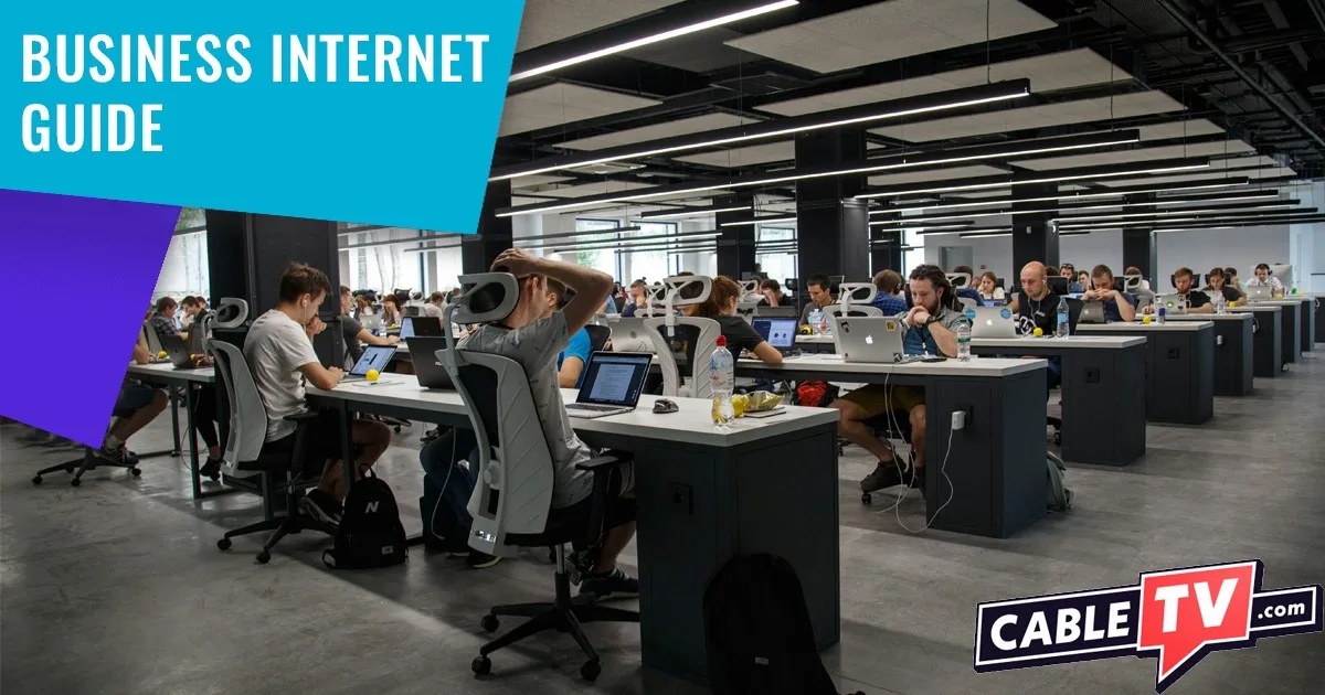 Rows of desks in busy office space with Business Internet Guide in top left corner