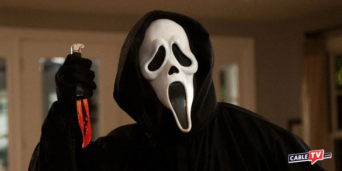 Screenshot from Scream movie of person wearing an elongated white mask and menacingly holding a bloody knife