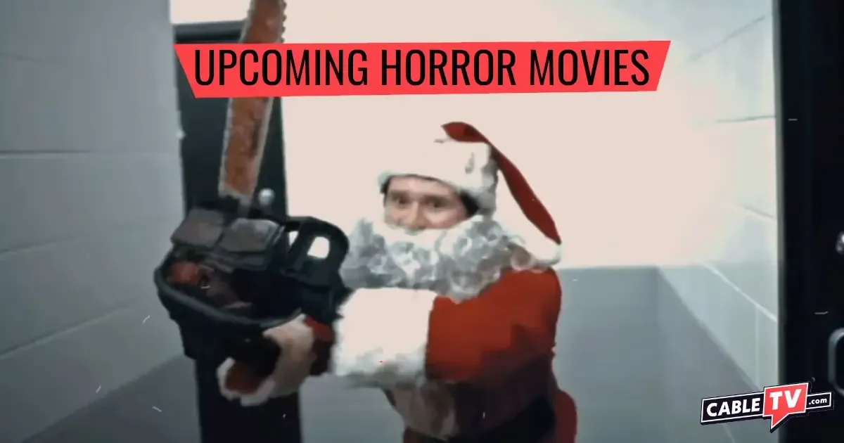In a scene from the upcoming horror movie remake Silent Night, Deadly Night, a man dressed in a Santa costume raises a chainsaw menacingly.
