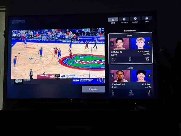 ESPN Unlimited Interactive A television displaying a men’s college basketball game with statistics to the right of the action.