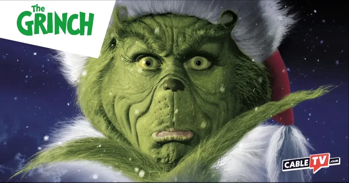 A close-up shot of Jim Carrey as the Grinch stroking his beard in Dr. Seuss’ How the Grinch Stole Christmas.