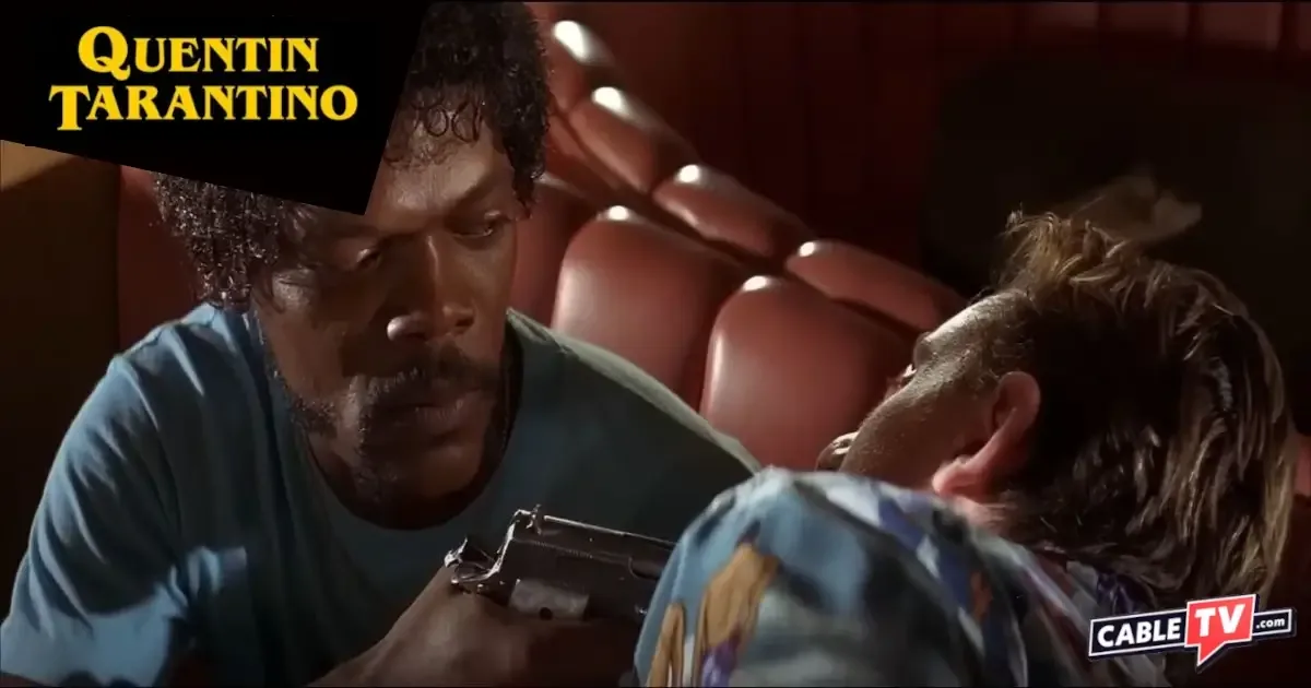 In a diner booth, a man holds another man at gunpoint, staring deep into his eyes. A scene from "Pulp Fiction."