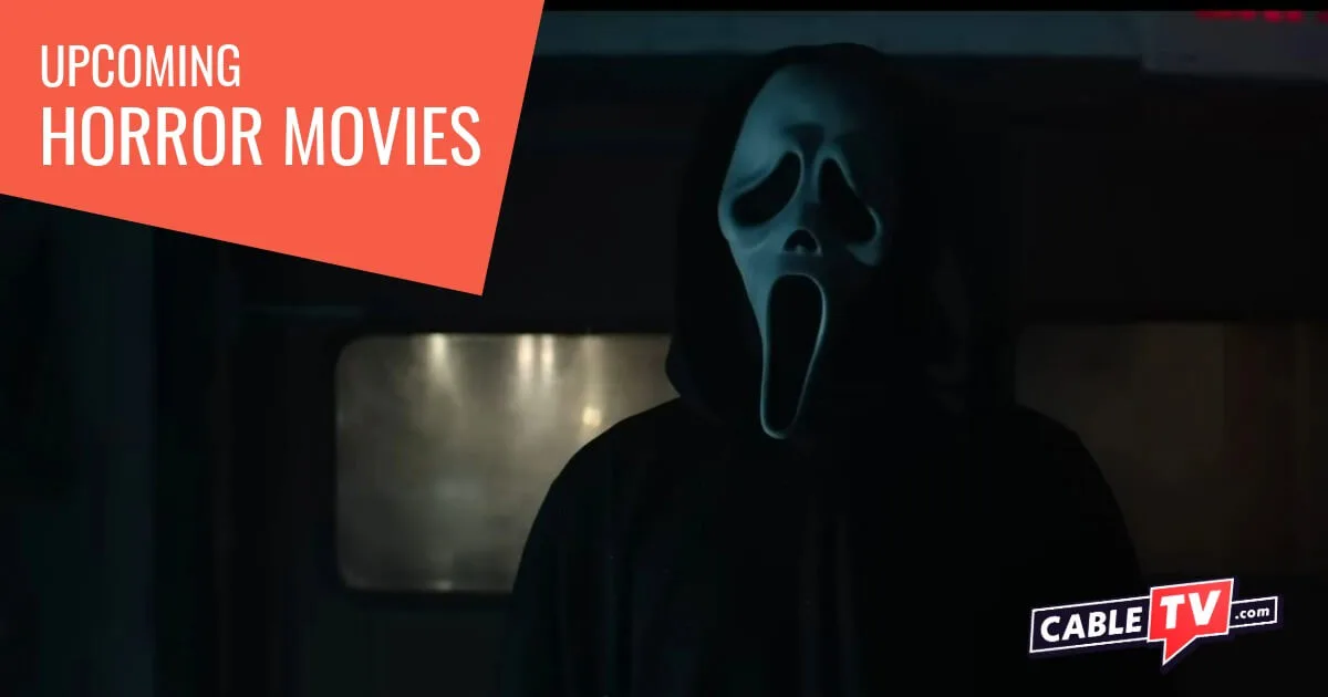 Ghostface, a man clad in a black hooded robe and wearing a ghost mask, pauses briefly in a scene from the upcoming horror movie Scream 7.
