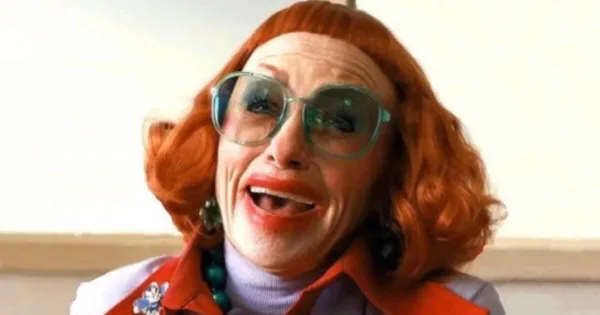 How to Watch the Golden Globes 2026 - Weapons A close-up shot of a smiling older woman wearing too much makeup.