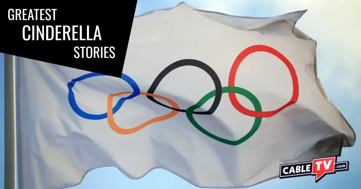 An image of the Olympic flag against a blue sky.