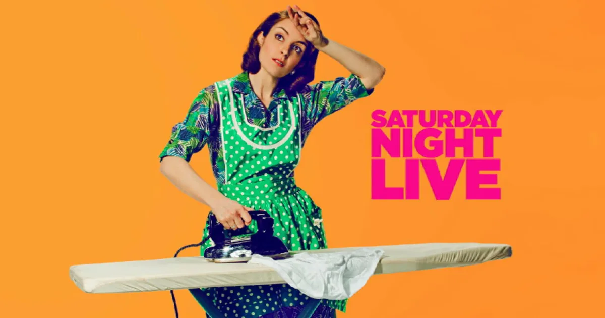 Tina Fey, dressed as a housewife, ironing clothes next to the SNL logo.