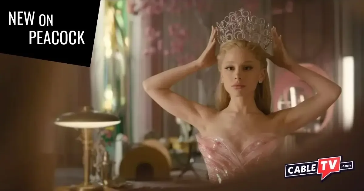 A young woman in a gown tries on a tiara and checks her look in the mirror.