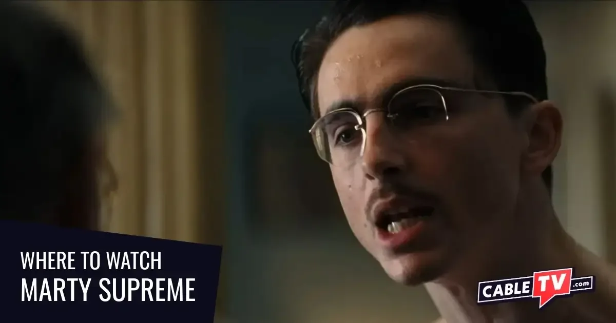 A close-up shot of a bespectacled man having a serious conversation with another man (seen from behind).