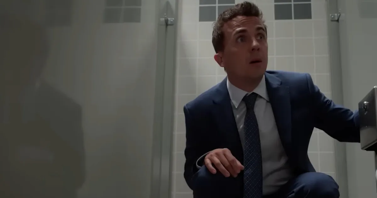 Frankie Muniz as a middle-aged Malcolm, hiding in a bathroom stall.
