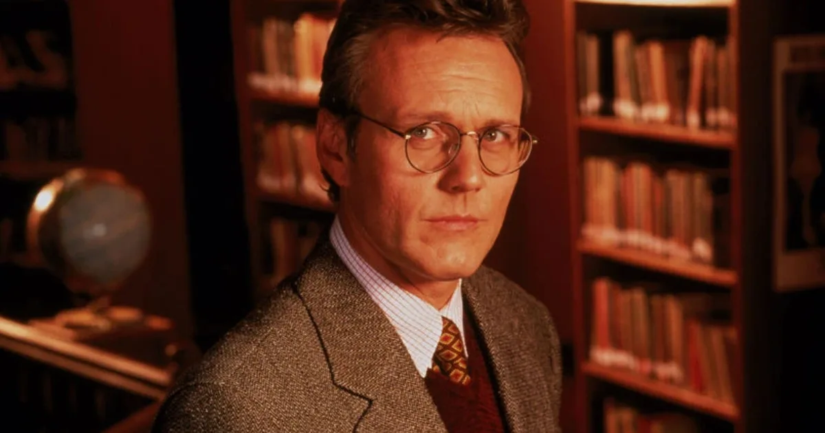 AnthonyHead1200x600 Anthony Head as Rupert Giles ('Buffy the Vampire Slayer'); a man wearing glasses and a tweed jacket stands in a library.