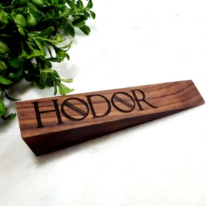 Hodor600x600 A wooden doorstopper with "Hodor" engraved in it.