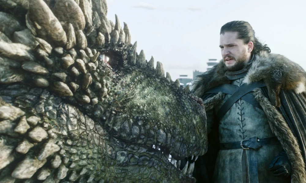 Rhaegal1000x600 Jon Snow looking apprehensively at a green dragon.