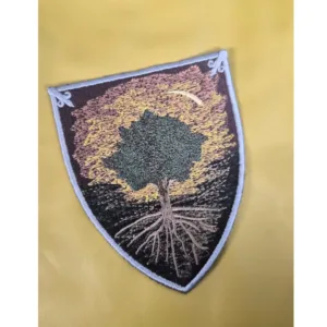 ShieldPatch600x600 An iron-on patch depicting a tree on a shield.