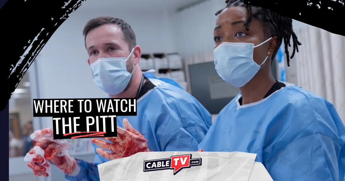 Two medical professionals with blood on their hands look up from the operating table.