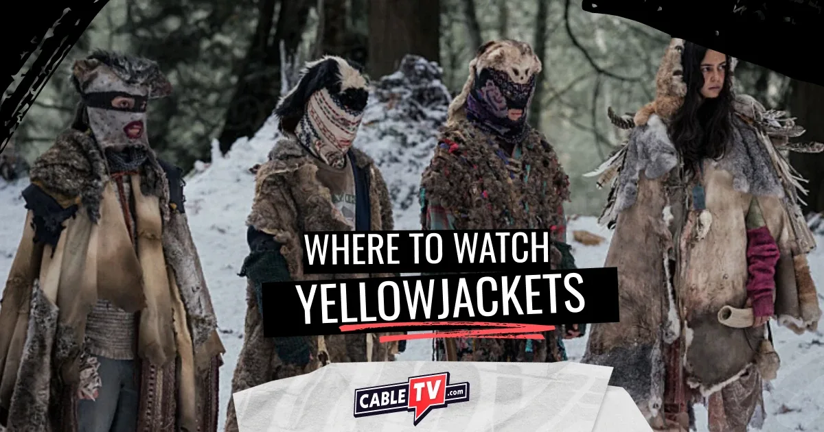 In a winter forest scene, four women bundled in skins and blankets stand shoulder-to-shoulder looking serious.