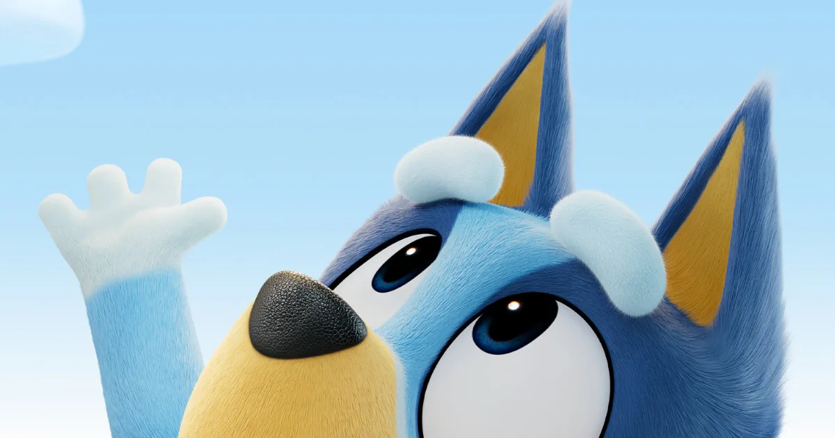 BlueyMovie1200x630 Bluey, a blue dog, reaches up towards the sky with one paw.